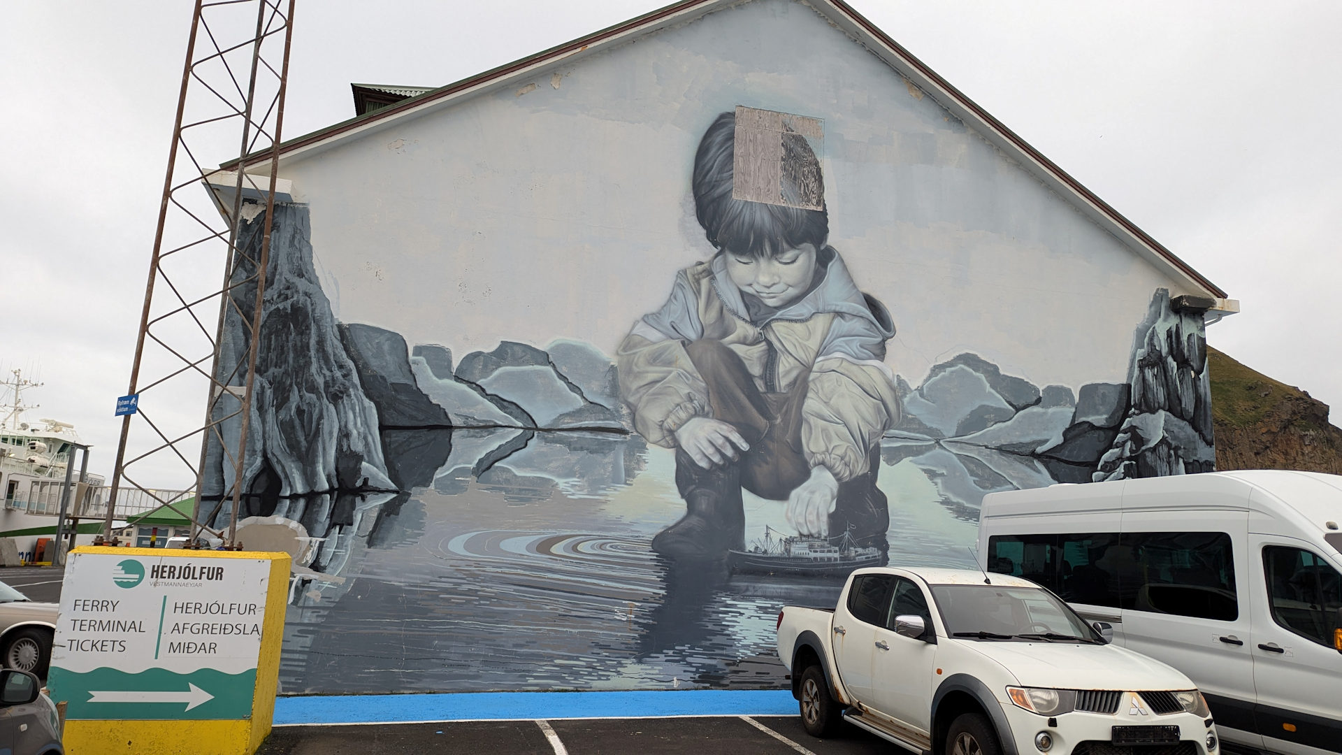 Wandbild mit einem kleinen Jungen, der mit einem Boot spielt. Vestmannaeyjar Island